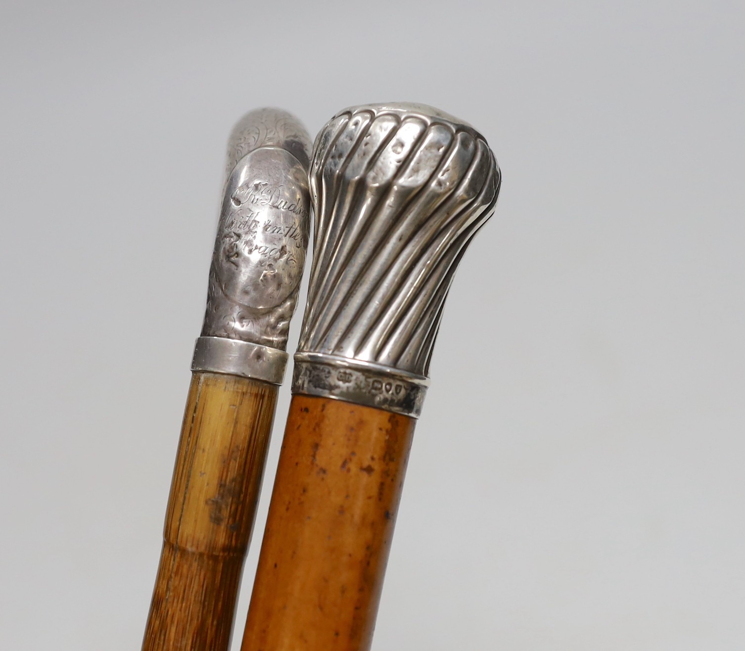 A silver-mounted malacca walking cane and a silver-mounted walking stick, 88cm